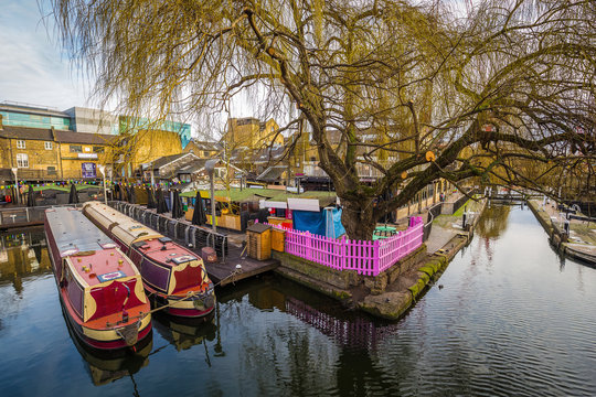 Lodon, England - The world famous Camden Lock Market with mooring houseboats and tree - Powered by Adobe
