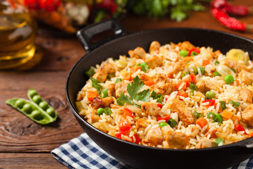 Fried rice with chicken. Prepared and served in a wok.