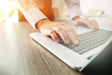 Businessman using laptop, close up