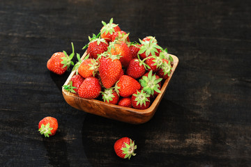 Strawberries in a bowl on a wooden table
