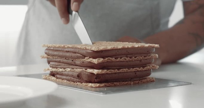 baker cut the slide of cake and serve it in dish