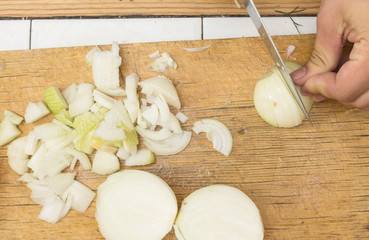 Onion cutting on a wooden cutting board