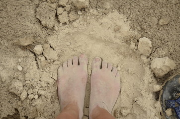 dirty foot in sand 