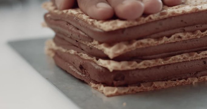 baker press layers of chocolate cake