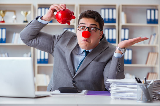 Clown businessman with piggy bank doing accounting