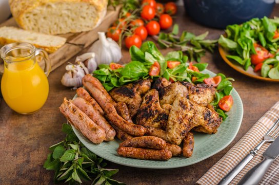 Grilled chicken wings and sausages