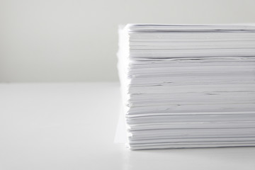 blank papers on white table,blank stack documents paper on office desk.