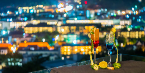 Two glass of cocktail and lemon with bokeh background from city light in christmas or new year...