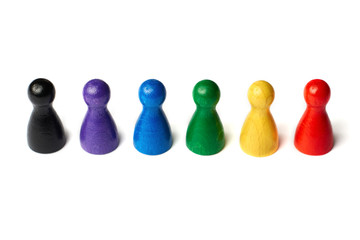 Colorful game figures standing in a line. Concept teamwork, diversity or rainbow colors.