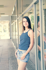 Pretty girl in a blue Topic and shorts posing in the city