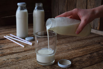 Sour-dairy drink or yoghurt in bottle that come from the kefir grains and milk on wooden...