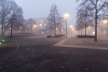 A plaza in the Petite France district of Strasbourg, France on a foggy winter morning at dawn.