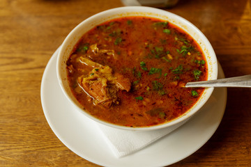 Traditional Georgian soup Kharcho with meat and rice on wooden background