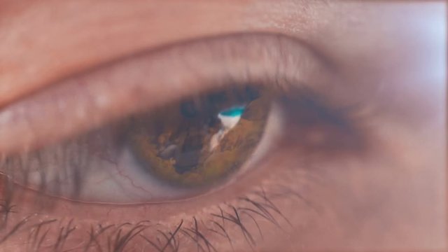 Fire reflecting in the pupil of a woman's eye.