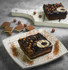 Sweet breakfast two chocolate brownies cakes. On  gray stone background the ingredients for chocolate cakes are balls and pieces of milk chocolate.