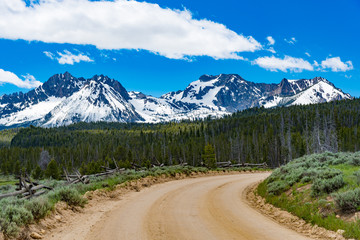 A dirt road leading to the Sawtooth Mountains