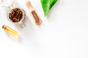 Spa treatment. Coffee scrub on white background top view copyspace