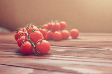 food background of fresh small tomatoes on wood in sunny day