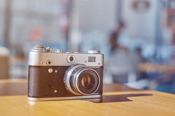 life style background of old film camera at sunny day on cafe table