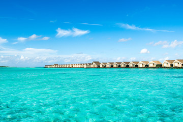 Fototapeta na wymiar Wooden villas over water of the Indian Ocean, Maldives