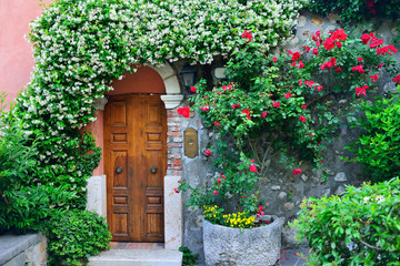 Fototapeta na wymiar Old door with flowers in Verona, Italy