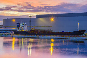 A merchant ship at the modern quay in the harbor