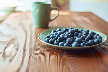 Fototapeta na wymiar food plate of blueberries on wood