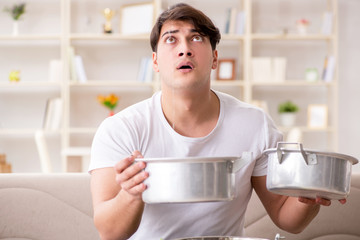 Man at home dealing with neighbor flood leak