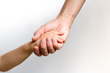 Close up of a woman's hand holding a child's hand