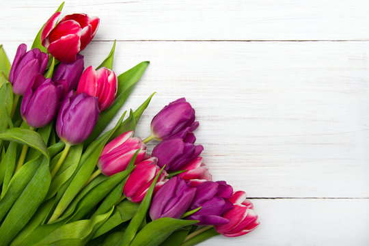Tulip bouquet on white wooden background, copy space