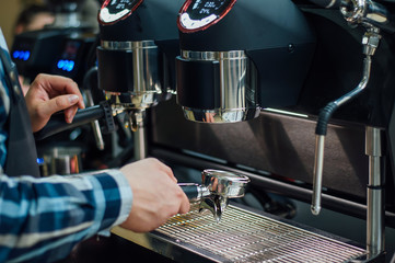The barman changes the streamer to a coffee machine for making coffee.Preparation and service concept, close-up.