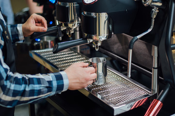 The barman changes the streamer to a coffee machine for making coffee.Preparation and service concept, close-up.