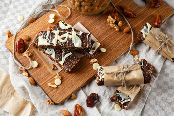 Organic homemade granola bars on wooden background - Healthy vegetarian vegan diet snack granola bars with nuts, seeds.