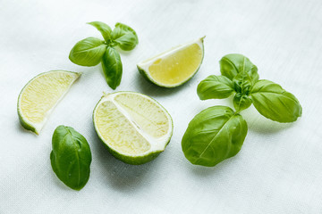 Fresh basil and lime on white background
