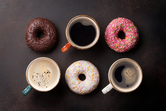 Coffee cups and colorful donuts