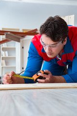 Young carpenter working with wooden planks