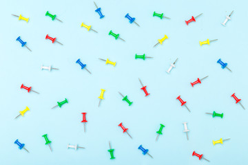 Set of office pins lies on a blue background. flat lay