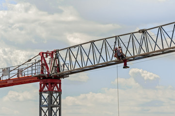 Electrician repairs an electric motor on a crane.