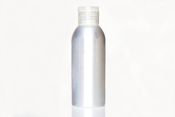 Aluminum metal empty bottle with plastic screw cap. Medicine or cosmetic clear package. Isolated on white background.