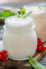 Obraz na płótnie Canvas Homemade yoghurt in a glass jar closeup.