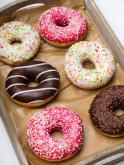 Colorful donuts with chocolate and icing, selective focus