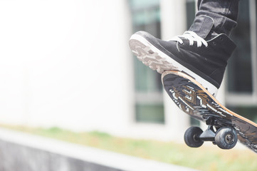 Boy skater is doing stunt at the street