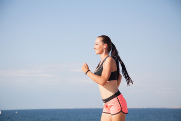 woman plays sports morning jog on the beach