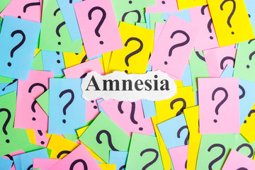 amnesia Syndrome text on colorful sticky notes Against the background of question marks