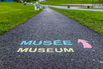 Colorful painted museum sign on asphalt pavement of plaines d'Abraham in Quebec City, Canada
