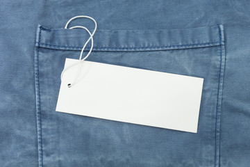 Empty white paper tag of jean, close up.
