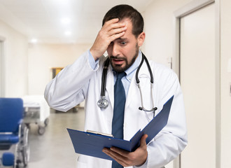 Desperate doctorl looking at a document