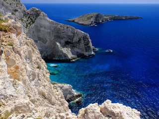 Beautiful perspective view on Zakynthos old amazing clift stone rocks blue water of Ionian Sea reefs Blue Caves and Ag. Ioannis island, Porto Vromi. Stone rocks Greece islands holidays vacations tours