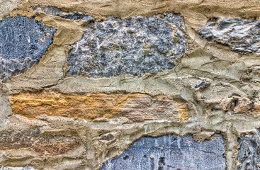 Closeup of old, colorful stone wall in Quebec City old lower town showing detail and texture