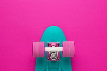 plastic mini cruiser board on deep pink with background with copy space